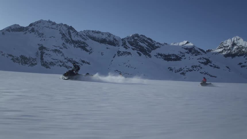 Group of people on snowmobile traveling in snowy environment