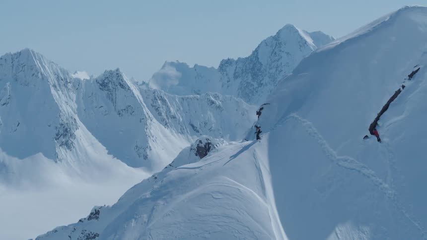 Person on a cliff on a snowy mountain