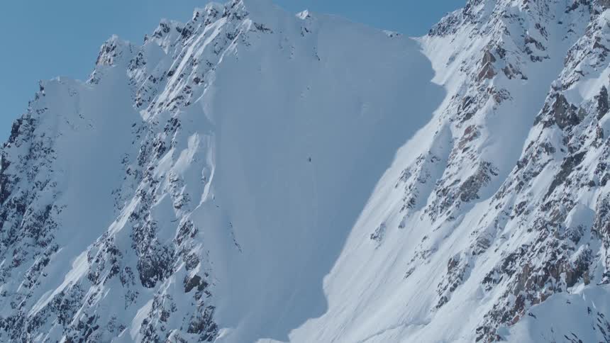 Snowcapped mountain with sharp peaks and steep slopes
