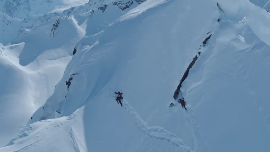 Two people climbing a snowy mountain