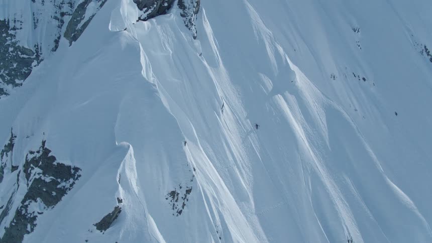 Isolated person climbing a snowy mountain