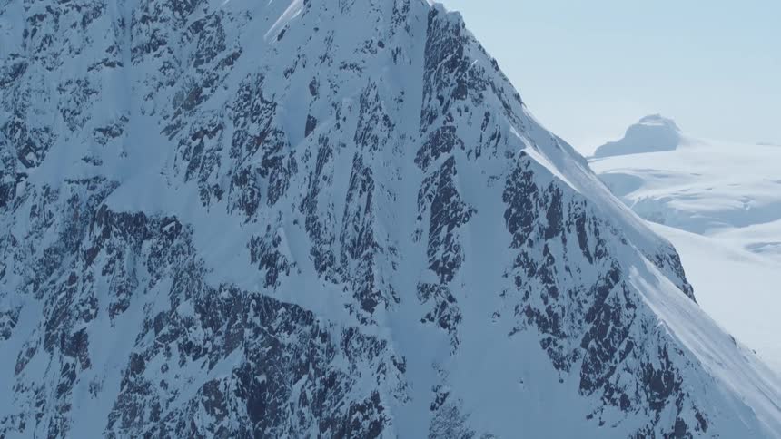 Aerial view of a steep mountain covered in snow