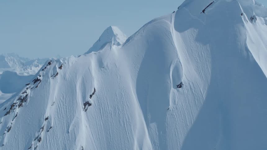Aerial landscape of a large mountain covered in snow
