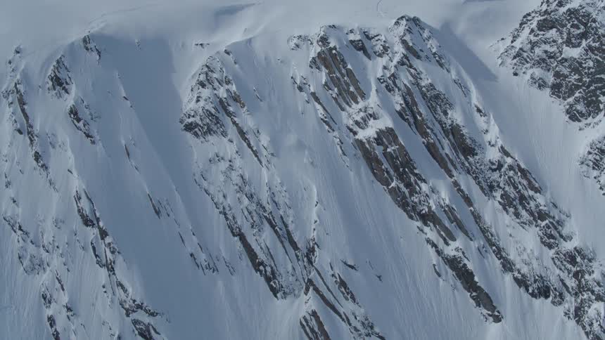 Aerial view of a person skiing on a snowy mountain