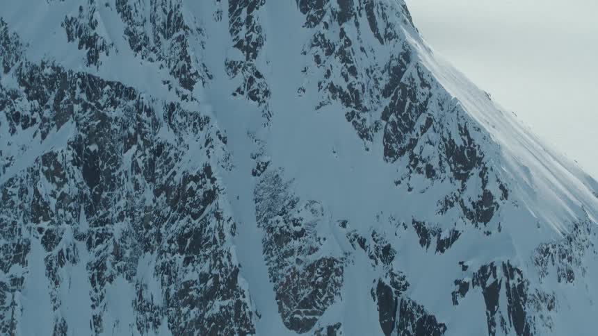 Aerial view of a person skiing down a snowy mountain