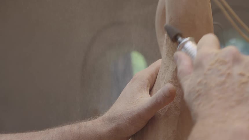 A clip of a person carving a wood