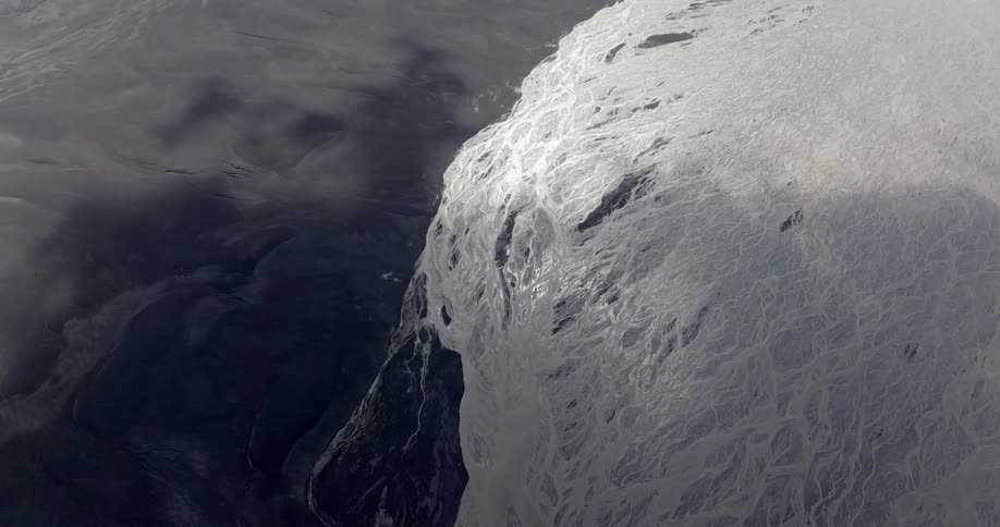 Large textured ice formation with a shadow cast on the surrounding terrain