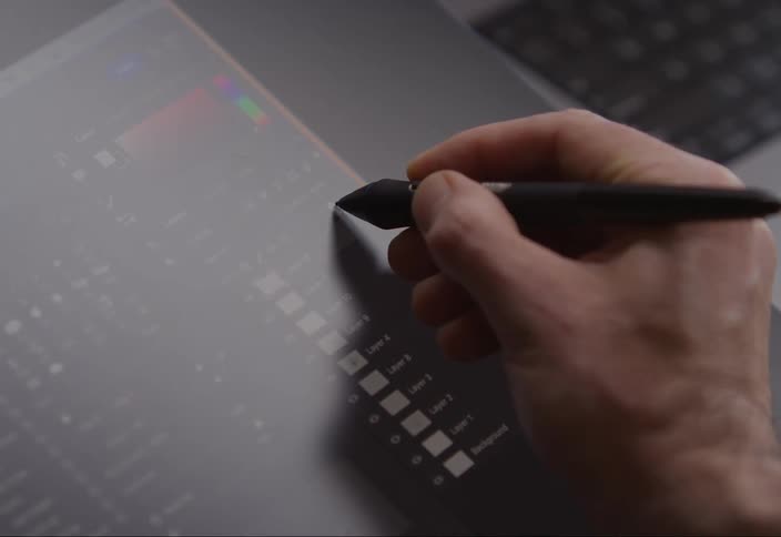 Hand with a digital pen interacting with a tablet