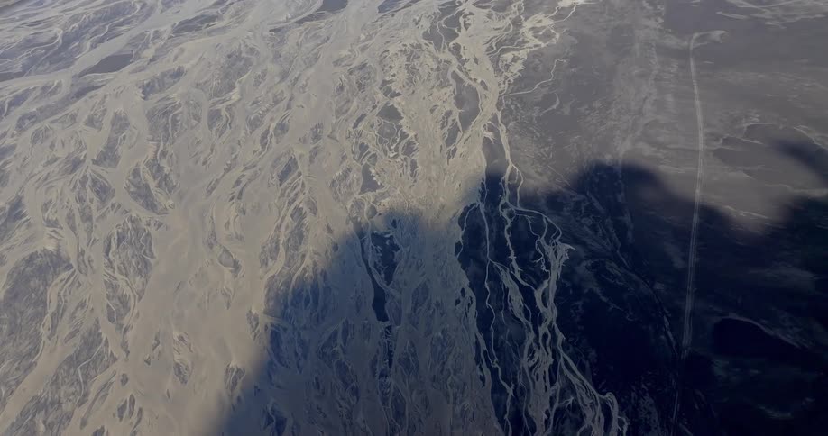 Aerial view of an arid landscape with intricate patterns of riverbeds