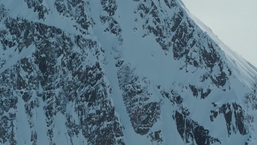 Person skiing down a large snowy mountain