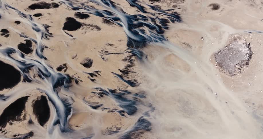 Aerial view of a sandy landscape with erosion patterns