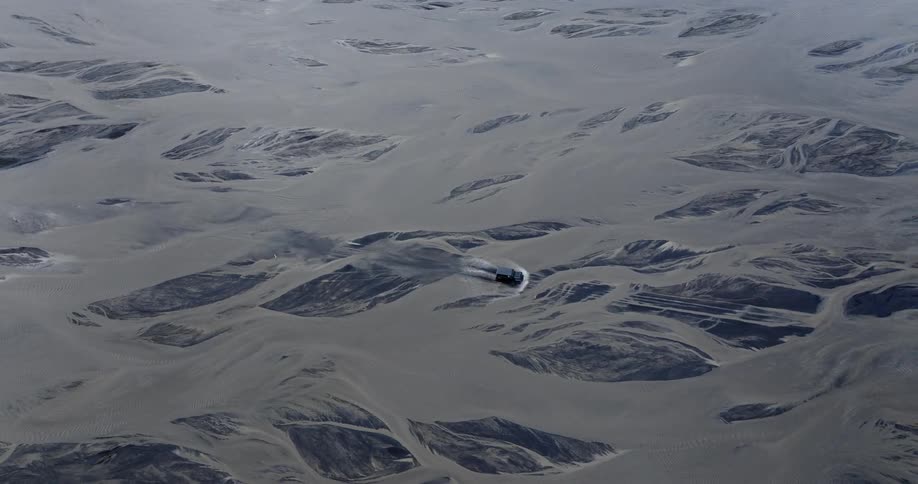 Aerial view of a vehicle crossing a large river