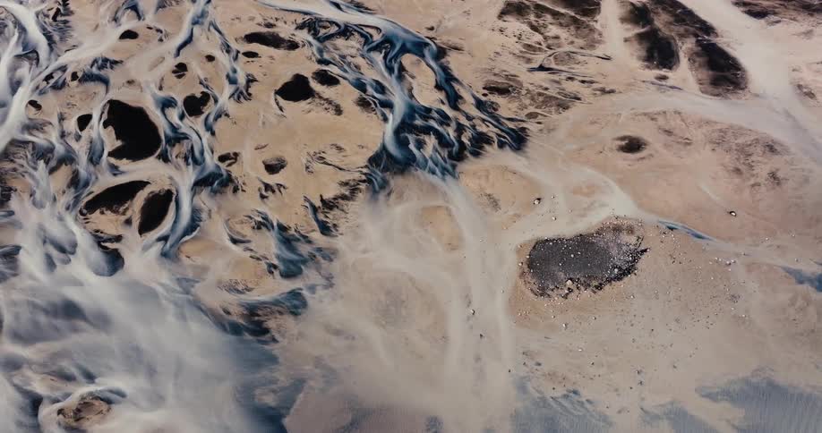 A winding river flows through a barren desertlike landscape