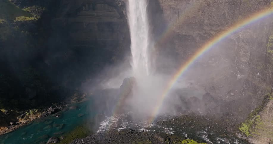 Landscape of a waterfall in a valley and the rainbow