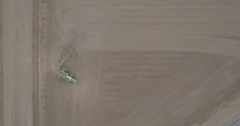 An aerial clip of a tractor grading a land