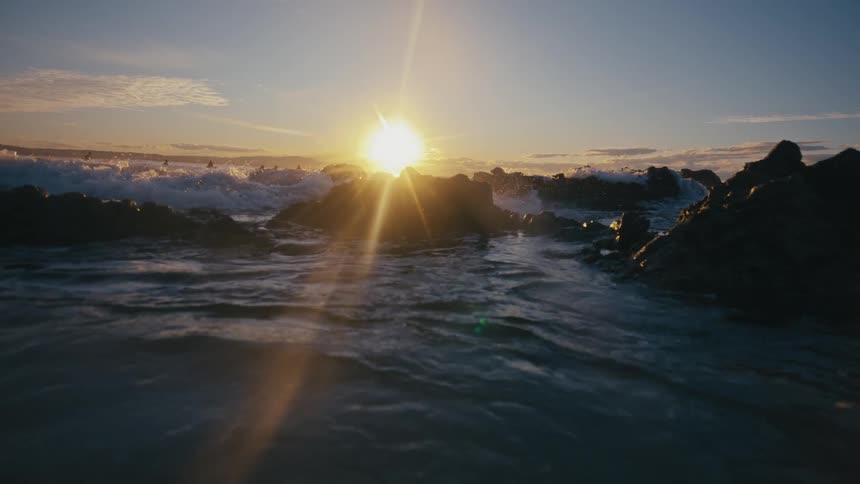 Sea landscape with rocks and sunrise on the horizon