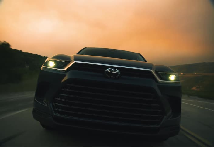 A black SUV charges to closeup and then passes