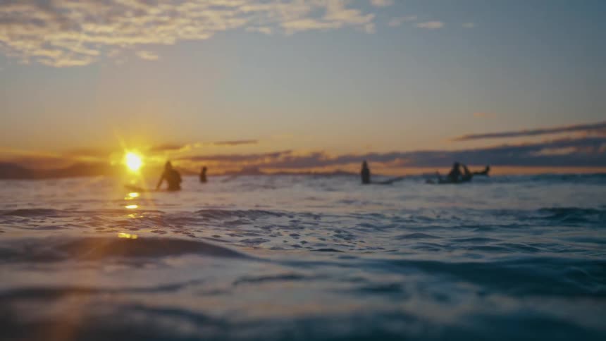 People are floating on their surfboards in the ocean