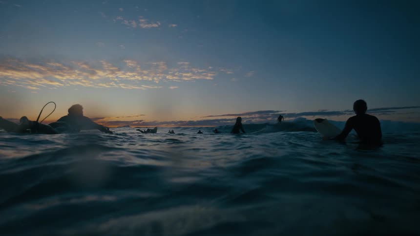 Group of surfers swimming in the ocean