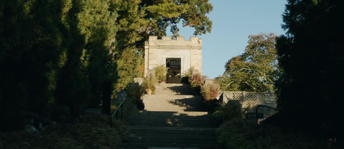 Staircase leading to an ornate stone gate overlooking the sky