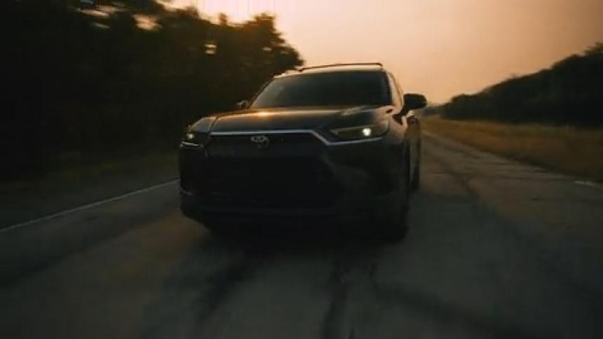 A clip of a black SUV moving down the road