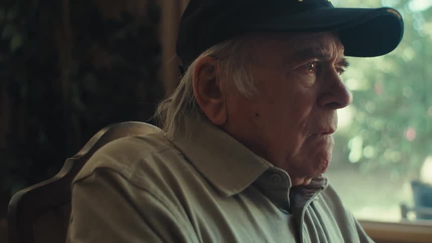 Elderly man sitting with sad facial expression