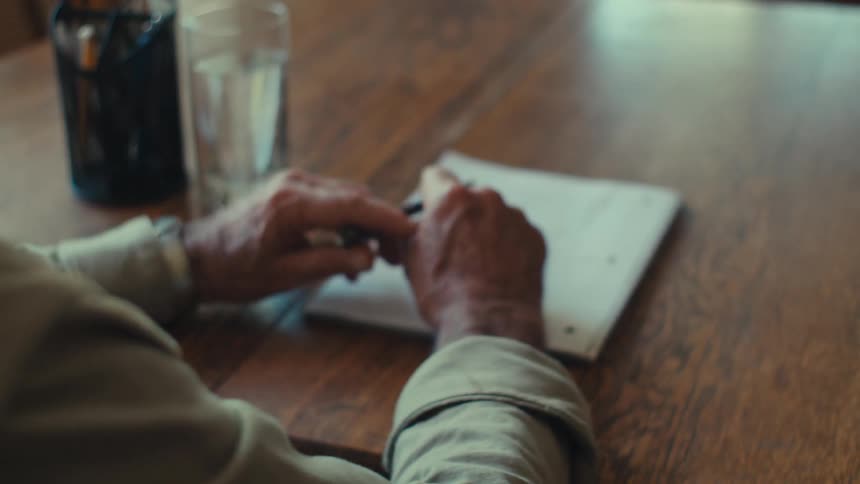 A clip of an elderly man writing