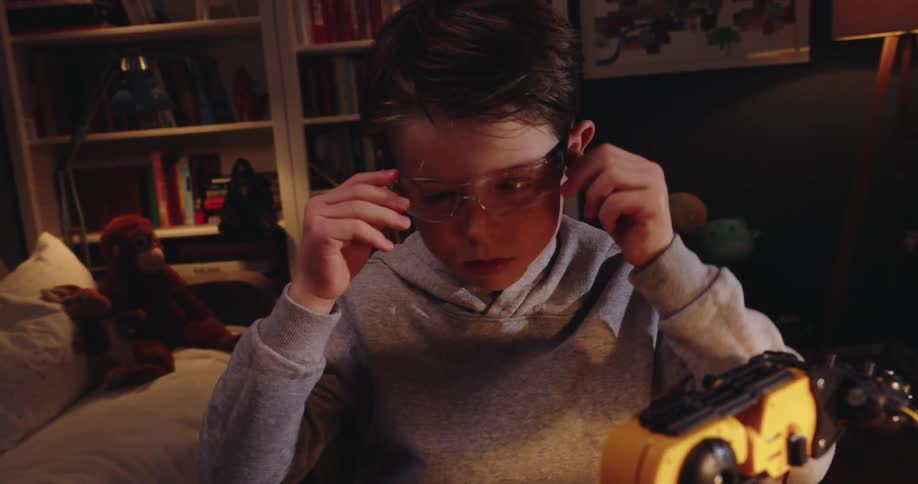 A clip of a kid wearing an eyeglass