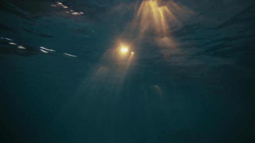 View into the ocean with reflection of the golden sun