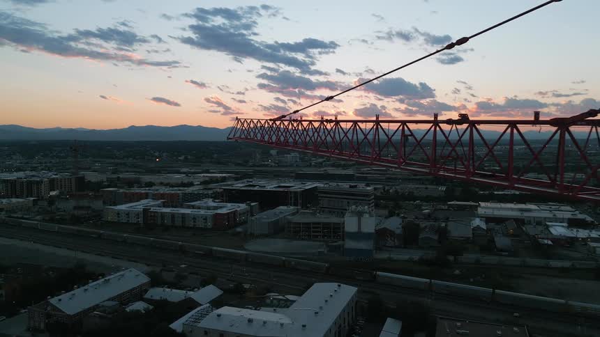 A large construction crane is over the city