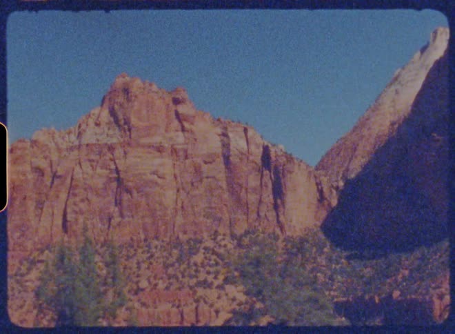 The rugged red rock cliffs of zion national park stand tall against a vast blue sky a testament to the raw power of nature