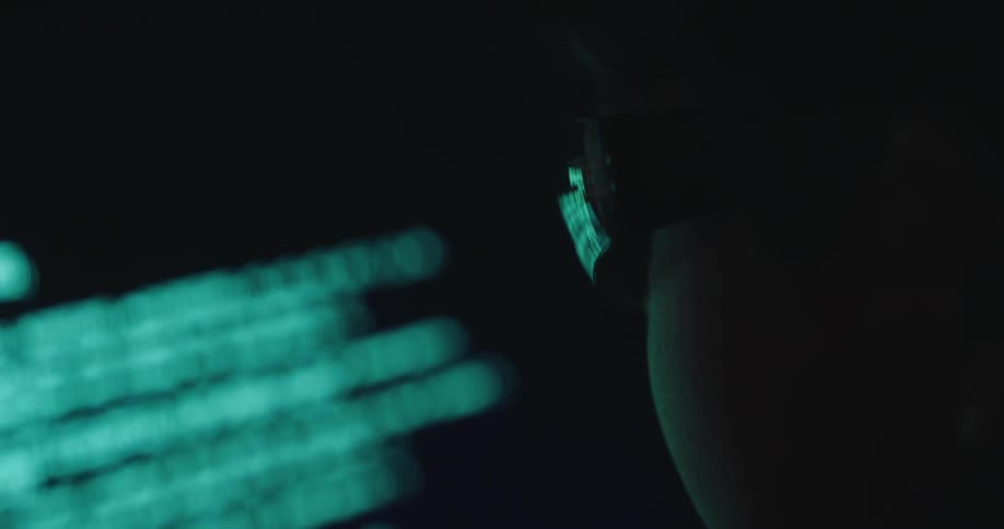 Little boy concentrating on source code displayed on a screen