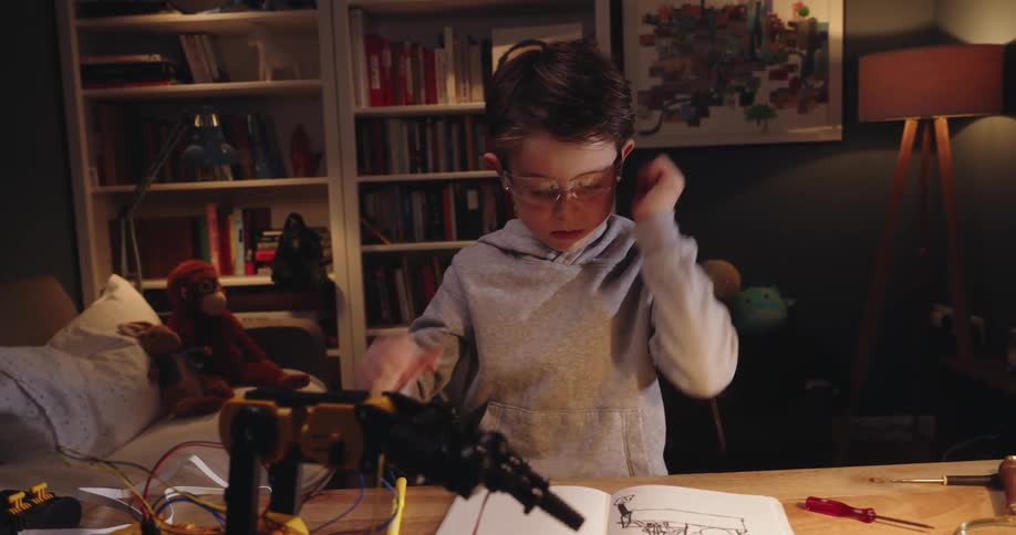 A clip of a kid designing a robot