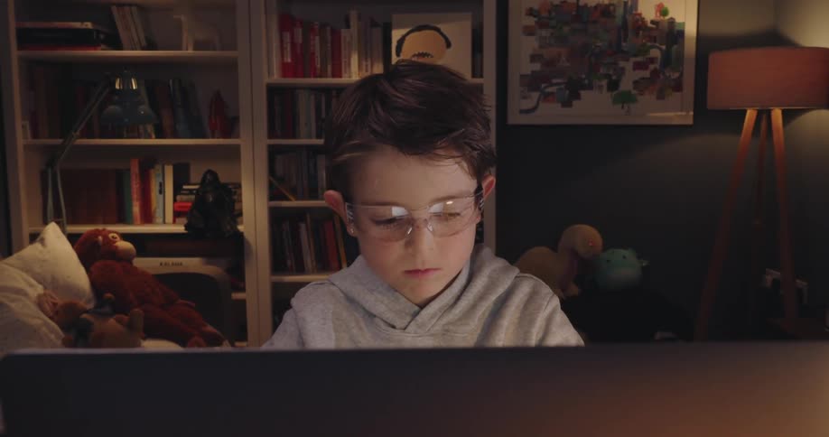 A child cheers as he plays video games