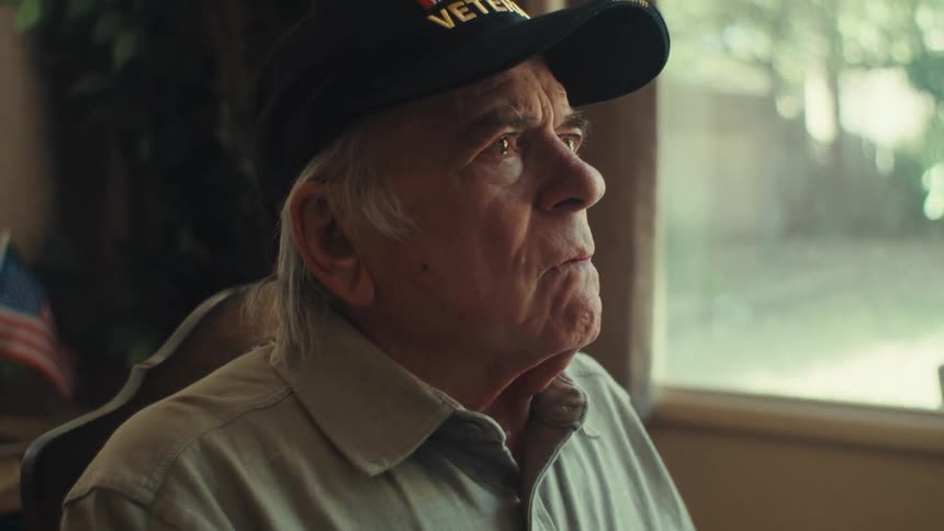 Elderly man sitting with expression of sadness and despair
