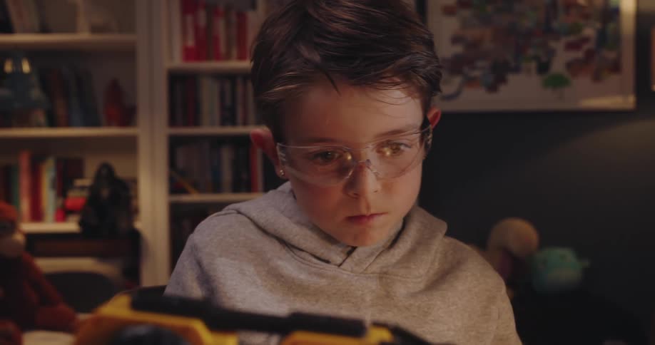 A child is examining his toy