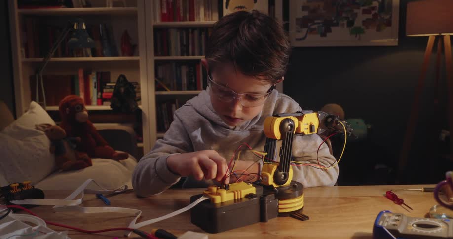 A clip of a kid fixing a robot toy