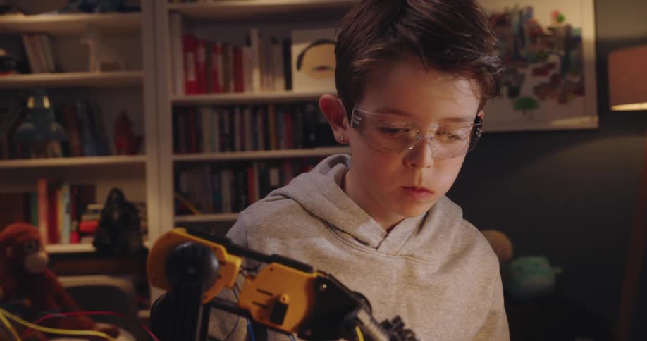 A close up clip of a kid designing a robot
