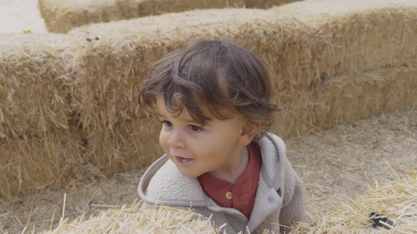A clip of a child walking in the middle of a farm produce