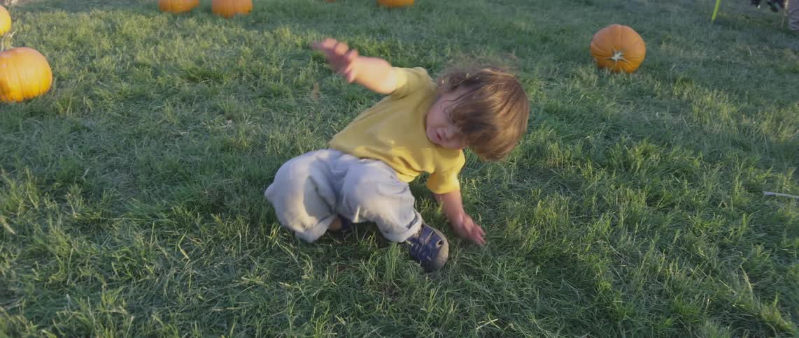 A clip of a kid playing on the grass
