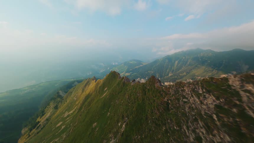 Aerial View of a Mountainous Landscape, Flying Through Clouds and Low Over the Mountain Ridge in Switzerland