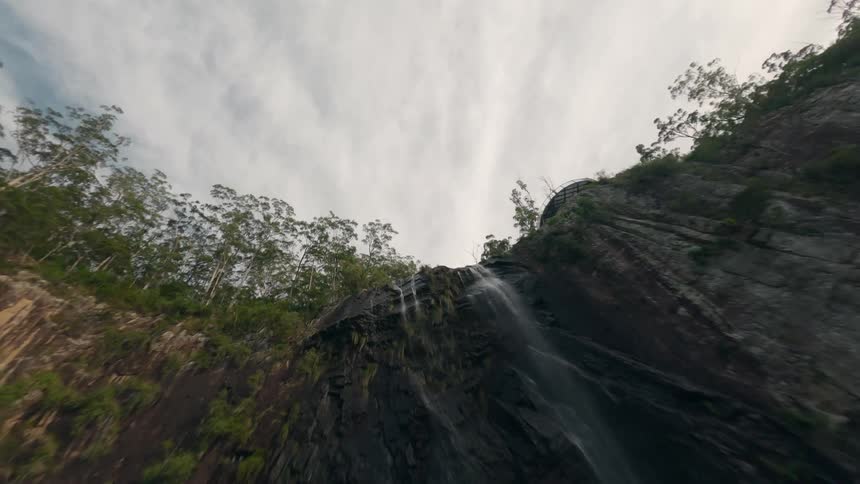 Man Standing on Edge of Waterfall, FPV Drone Flips Over and Falls Backwards Down the Waterfall