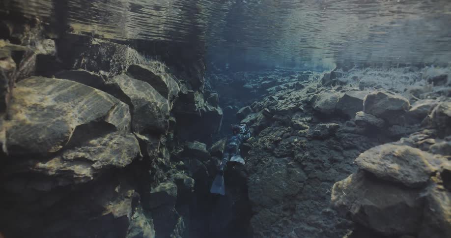 A diver is taking photographs underwater