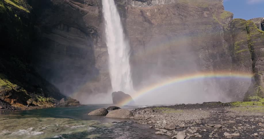 Double rainbow under a rapidly cascading waterfall in the canyon