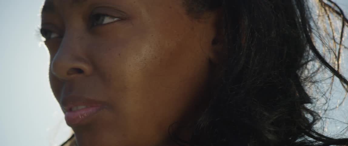 The sun shines down on a woman