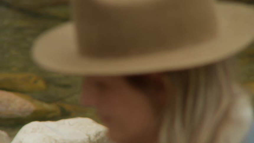 A woman is on a stream bed