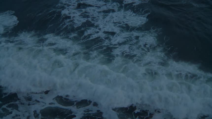 A view of the ocean waves crashing against the shore