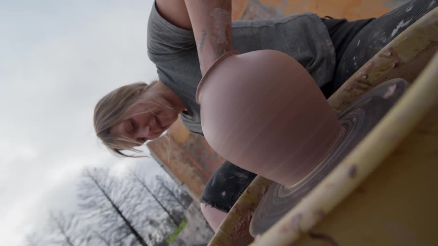 Woman working on a clay pot