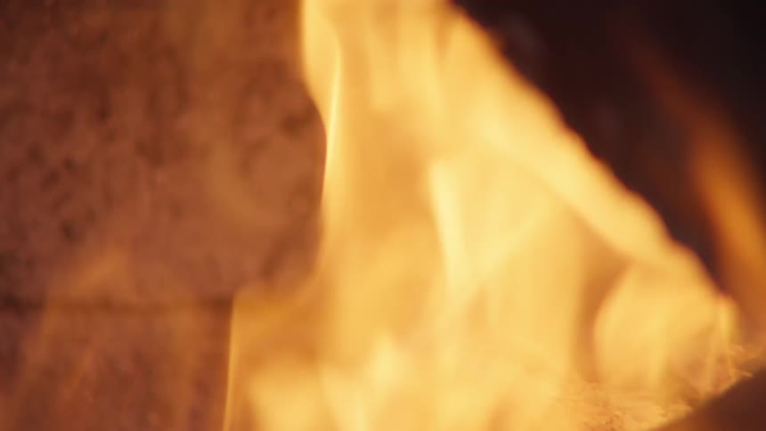 A closeup view of a furnace with a roaring fire