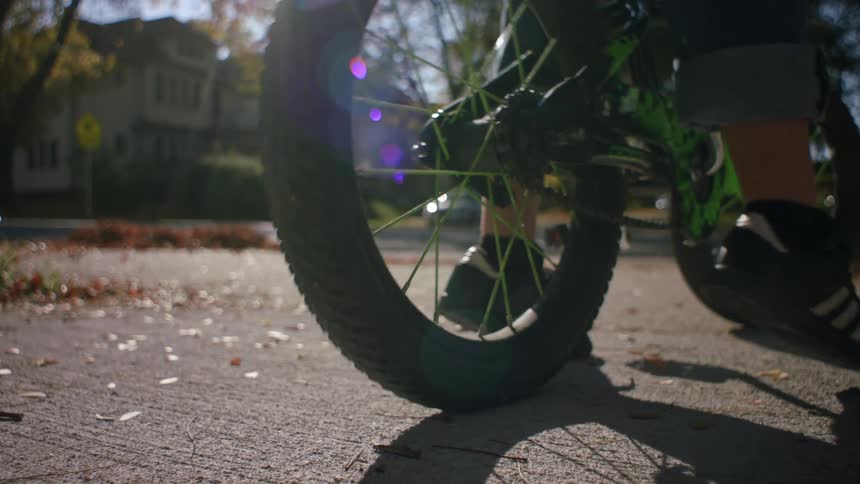 Legs of a child on top of a bicycle